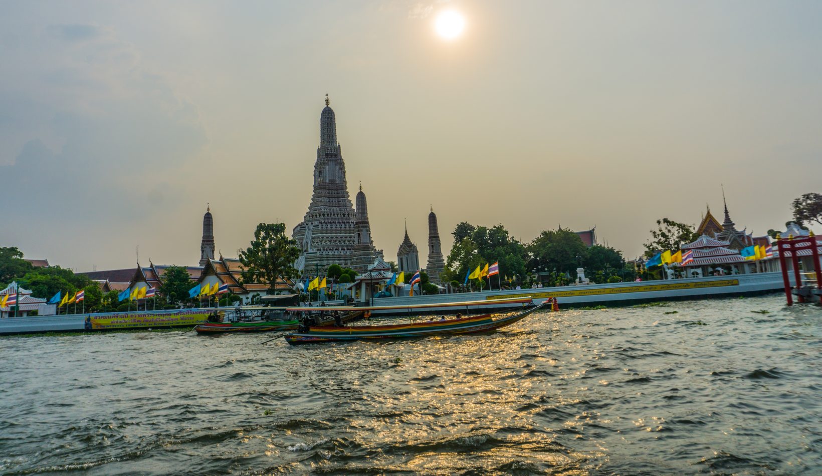 Wat Arun temple at sunset on the Chao Phraya river, Bangkok